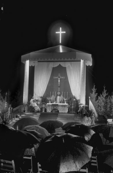 Archbishop Moses E. Kiley of Milwaukee and other clergy at the altar on Breese Stevens Field celebrating Holy Hour. Intentions of the Holy Hour for this year were: gratitude for the end of hostilities, national security, harmony among nations, and a firm, just, and lasting peace.