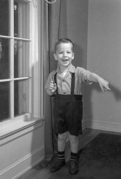 Portrait of Gerald B. Wassenaar standing near a window. His birthdate was August 5, 1942.