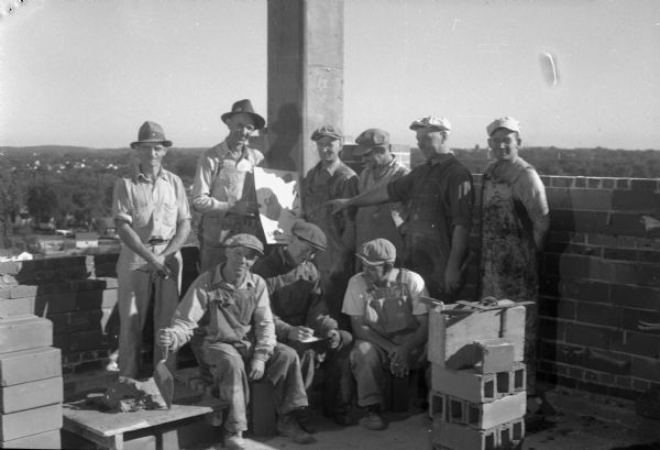 Group portrait of Madison Building and Construction Trades workers signing pledge cards to donate one day's pay (about $12) to Madison War Chest campaign.