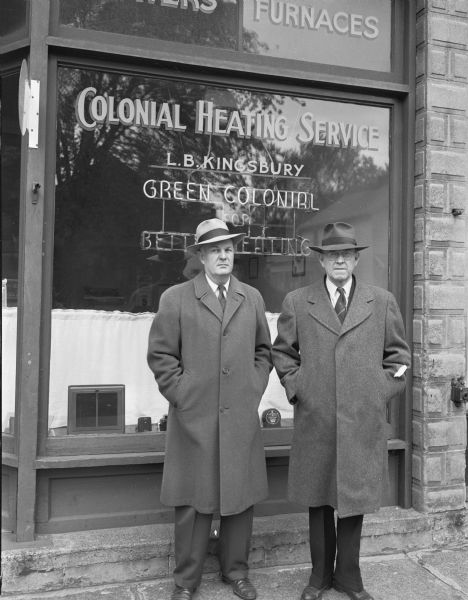 Two men standing in front of the Colonial Heating Service store, 1148 Williamson Street. Photograph taken for Martin Johnsrud?