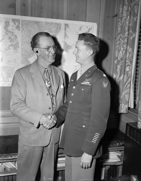 Roundy Coughlin shaking hands with Lieut. Col. Royal Thompson as they renew their acquaintance from attending a baseball game in Chicago when Royal Thompson won a State Journal circulation contest.