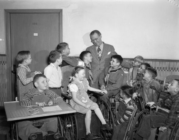 Joseph "Roundy" Coughlin shown with a group of children at Washington School as part of his charity fund raising for "Roundy's Fun Fund."