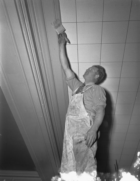 Ray Kessenich, Klein-Dickert Co. foreman, painting the trim in a Ray-O-Vac office at 212 East Washington Avenue.