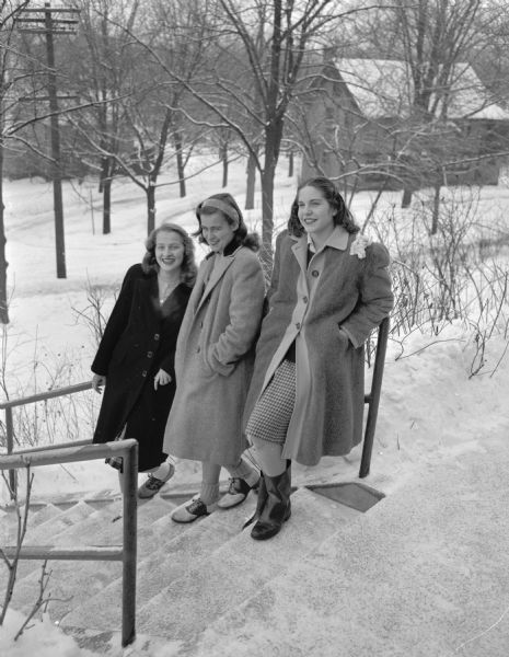 Three Madison girls, students at Kemper Hall in Kenosha, visiting in Madison during their Christmas holiday. Left to right are: Margot Schmidt, daughter of Dr. and Mrs. E.R. Schmidt, 1937 Arlington Place; Ruth Tyrrell, daughter of Mr. and Mrs. Donald W. Tyrrell, Shorewood Hills; and Karen Vea, daughter of Mr. and Mrs. Norman Vea, 4201 Manitou Way.