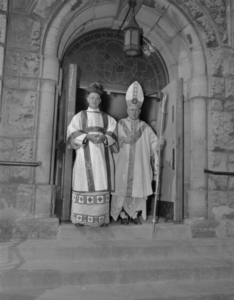 Most Rev. William P. O'Connor, the first Bishop of the Madison diocese, on the steps of St. Raphael's Cathedral, after the ceremony where he was inaugurated as bishop. Standing with him is (probably) Most Rev. Moses E. Kiley, Archbishop of Milwaukee who presided at the ceremony.