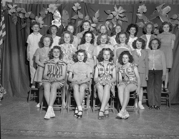 Group portrait of twenty school children and youth wearing clothing from the Emporium Department Store featured in the Cottage Grove Grade School Style Show.