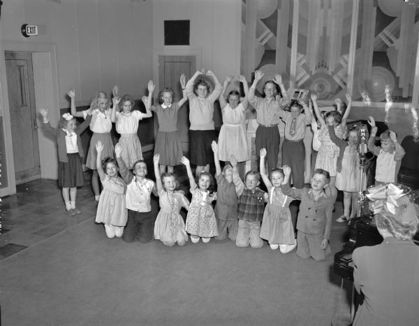 Wisconsin School of the Air program, featuring Fanny Steve at the piano leading a group of children in a rhythm game. Her popular show, "Rhythm and Games" was heard in classrooms throughout the state.