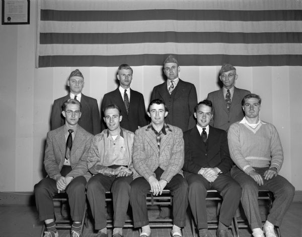 Group portrait of members of the newly established Veterans of Foreign Wars Post at the University of Wisconsin-Madison campus, the first of its kind on a college campus. Pictured left to right: front row, Ronald Yates, Mukwonago; August Zellmer, Spooner; Bob Schultz, Milwaukee, Quarter Master; Howard Day, Ottawa, Illinois, Adjutant; Dan Haight, Evanston, Illinois, all members. Top row, left to right: Paul Lappley, Robert W. Fisher, Commander; Lyall Beggs, and Edward Watland. Lappley, Beggs, and Watland are members of the Marion Cranefield Post of Madison.