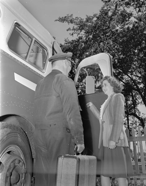 Lorraine Thelen shown boarding one of the "fast express" buses operating between Madison and Milwaukee by Badger Coaches, Inc. The driver shown is Bill Best, a driver with over thirteen years experience.