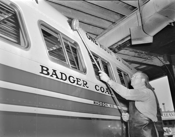 Henry Murphy washing the Badger Bus Line, Inc. coach that he drives between Madison and Milwaukee.