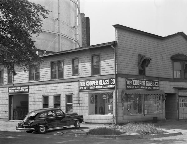 Bob Cooper Glass Company building, 755 East Washington Avenue. There is a large tank in the background.