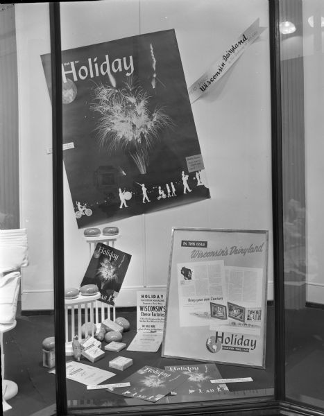 Window display featuring the July, 1946 issue of <i>Holiday</i> magazine. In this issue is an article called, "Read about Wisconsin's Dairyland" by Phil Drotning. Taken for Ed Crossman, agency supervisor for Curtis Circulation Company.