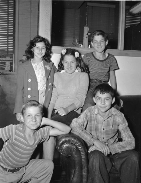 Group portrait of 5 children who put on a neighborhood circus behind the Bonura home at 617 Spruce Street to raise money for Roundy's Fun Fund.  They charged 2 cents per ticket and raised $5.50. Top row left to right:  Mamie Bonura, June LaFlash, and Bernard LaFlash. Bottom row: Roger LaFlash, and Nick Bonura.
