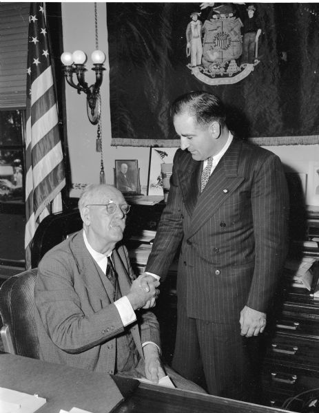 Governor Walter S. Goodland (left) and Circuit Judge Joseph R. McCarthy (right), Republican nominees for governor and senator, exchanging promises of support. McCarthy had called on Goodland in the executive office shortly after his victory in the Republican primary.