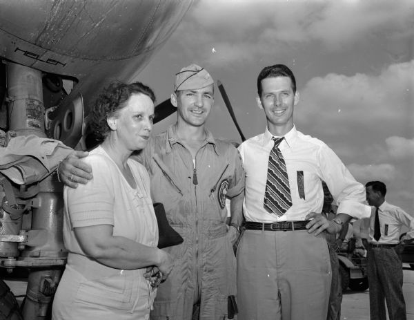 Mrs. J.C. Ferguson, pilot Major Woodrow Swancutt, and Dick Johnson standing in front of B-29 airplane, "Dave's Dream" at Truax Field.  Major Swancutt, a Wisconsin Rapids native, attended the University of Wisconsin where he had won fame as an intercollegiate boxing champion.