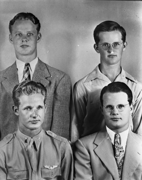 Group portrait of four men, including one in uniform, taken for the Hankscraft Company, 1007 East Washington Avenue. Photograph may include Marshall W. Hanks, president, J.B. Ramsey, vice-president, and Wayne Ramsey, secretary-treasurer.