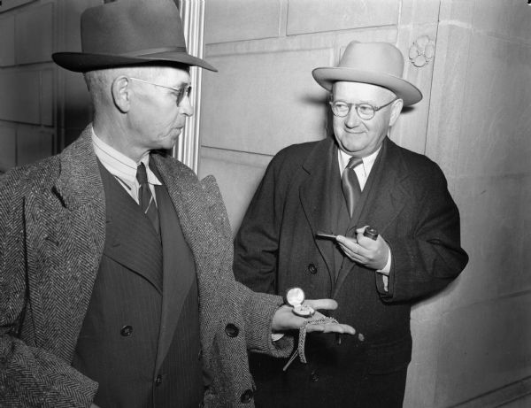 Harry B. Haley (right) bought the diamond pin and 662 jewel bracelet held by George H. Brown, chief deputy U.S. Marshal for the Western Wisconsin District court for $1,300. A soldier, Rudolph W. Schleusner of Menomonie, had found the jewelry in an abandoned house in Germany and sent them to his wife. When the Schleusner's asked the customs office about import duties, an appraiser said they were worth $1,200 and Federal Judge Patrick T. Stone ordered them forfeited to the government.