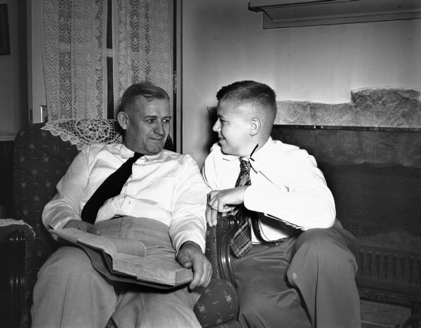 Two men sitting in a living room. Possibly U.S. Secretary of Commerce Henry Wallace and Howard McMurray, Democratic candidate for senate.