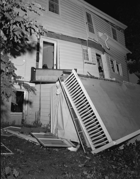 Exterior of the house of Profesor Donald D. Lescohier, 1311 Morrison Street, damaged by a gas explosion in the kitchen, which was at first thought to have caused the death of Professor Lescohier's wife, Ethel Mae. The cause of  her death, however, was determined to be suicide by carbon monoxide poisoning before a gas explosion.