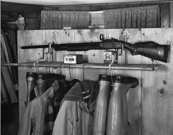 Horizontal gun rack located on a closet shelf taken for the R.L. Kulzick Advertising Agency, 409 East Washington Avenue.
