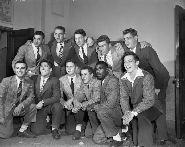 Group portrait of the Shriner's Annual All-City High School Football Team, sponsored by the Madison Zor Shriners, taken at their 8th annual football banquet held at the Masonic Temple, 301 Wisconsin Avenue. Front row left to right: James Devine, Edgewood; Tom McCormick, Edgewood; Dean Beyler, Edgewood; Walter Heilman, Edgewood; Al Dockery, Central; and Harry Gilbert, West. Back row left to right: Ken Sachtjen; Neil Schlicht, East; Barron Cawley, Edgewood; Bob Mansfield, West; and Jack Hall, East.