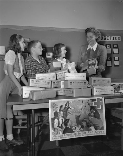 Lapham School students with gift boxes prepared by Junior Red Cross members to be sent to boys and girls overseas. Shown with teacher Gladys Halvorsen are, left to right: Mary Lou Hillebrand, Dick Simonson, and Patricia Nicholson.