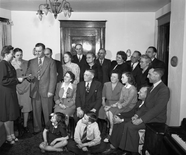 The Fitchburg Farm Bureau council, meeting at the home of Mr. and Mrs. Ed Blaney, Route 3, presenting a check to the American Cancer society field army, and asking that the field army open cancer detective centers in rural Dane County. Front row, on the left, Mrs. Ralph Jacobs, captain of the Western Dane County Society, Mrs. Paul Phillips, lieutenant of Middleton township, Arthur Fleming, president of the Fitchburg Farm Bureau Council.