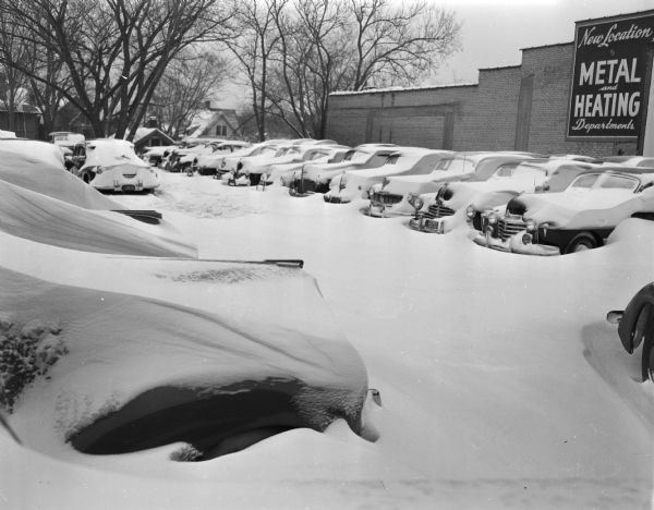 Winter scene with cars in a parking lot at West Washington Avenue and Fairchild Street the morning after a snowstorm, Madison, Wisconsin.