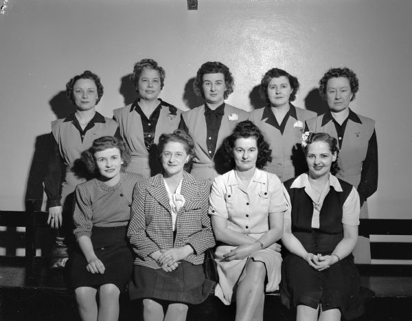 Group portrait of individuals and members of the Bowman Dairy team, winners in the Annual Women's City Bowling tournament. 
Front row seated, l to r: Bertha Showers, Gertrude Pertzborn, Priscilla Siewert and Ora Ehl. Back row standing, l to r: Lorraine "Honey" Kritlow, Avis Kidd, Martha Hoffman, Hazel Hoven, and Ruth Hoffman.