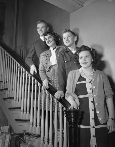 Labor Union party sponsored by the YWCA Industrial Committee, with many activities. Shown are four children of Labor Union members, l to r: Don Dowling, Betty White, Gordon Morris, and Pauline Coyier, standing on a stairway.