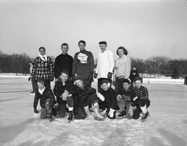 Group portrait of the winners in an annual city skating meet,  front row, l to r: Phillip Oren, Dick Simonson, Gail Wold, Patsy Gibson, Gary Melcher, and Herb Skinner. Back row, l to r: Marilyn Roth, Jim Devine, Bill Carow, Bob Lea, and Clara Skinner.