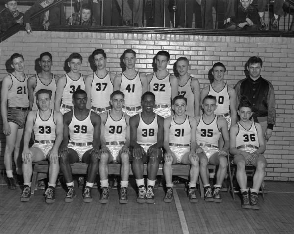 Group portrait of the Central High School boy's basketball team and coach, Front row l to r: Pat McCann, Al Dockery, Mel Troia, Bill Withers, Allen Sweet, Frank Fellows & Keith Tipler. Back row l to r: Robert Gesme, James Weaver, Robert Schaefer, Alvin Starck, Robert Ziesch, James Wilcox, Ken Sticha, Don Gasser, and Coach Robert Alwin.