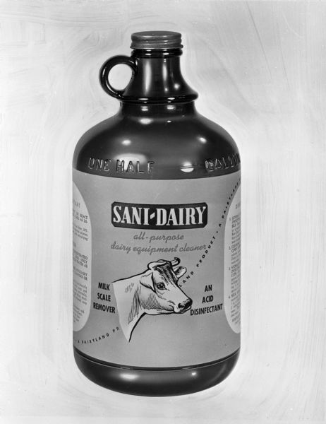 One-half gallon bottle of Sani-Dairy all-purpose dairy equipment milk-scale remover and disinfectant.