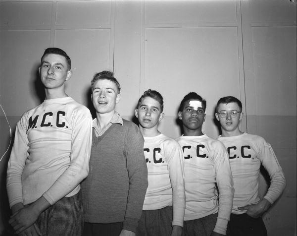 Group portrait of the LOFT's ice hockey team. From left to right are: Dick Thern, Dave Scott, Jack Germann, Jim Green, and Bob Fuller. Another player, Martin Kammer, was absent at the time the picture was taken.