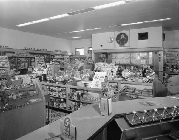 Interior of Rennebohm Drug Store, 2526 Monroe Street, showing display counters and soda fountain.