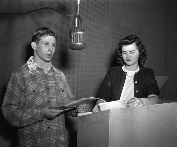 George "Skip" Stebbins and Anne Holden , co-chair of the Young Council radio committee, presents a program for the Council which broadcasts each Saturday night over WIBA. The March program marked the first anniversary of the radio series.
