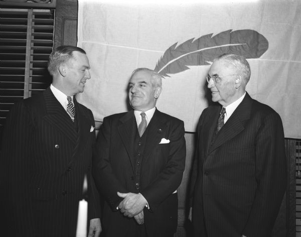 At the Community Union's twenty-fifth anniversary, Fred K. Hoehler,  the main speaker, stands between D.A. Forsberg, left, and chief Justice Marvin B. Rosenberry, first president of the organization, at the Park Hotel, 22 South Carroll Street.