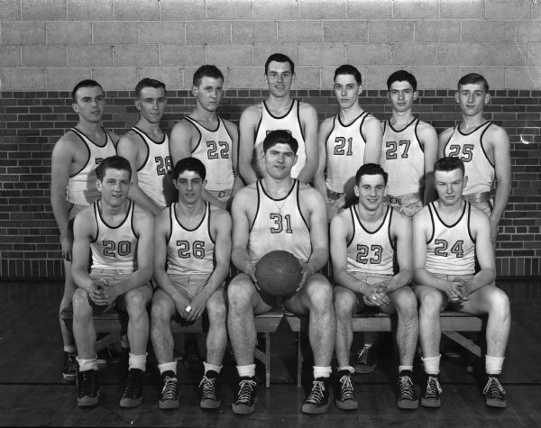 Group portrait of Edgewood High School basketball team, participating in the Catholic School Tournament.