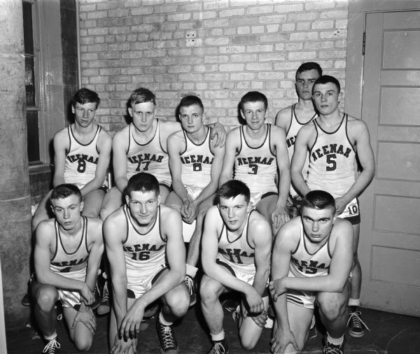 Group portrait of the Neenah High School boys basketball team who participated in the consolation game at the WIAA State High School Basketball Tournament.
