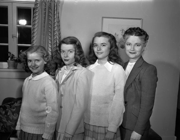 Mrs. Wilbur C. (Hattie) Carlson and her three daughters, Judy, (10), Jean (16), and Sally (12). Mr. and Mrs. Wilbur Carlson moved to Madison from Elgin, Illinois, and he is assistant to the president of Kraft Foods Company. The Carlsons reside in Maple Bluff.