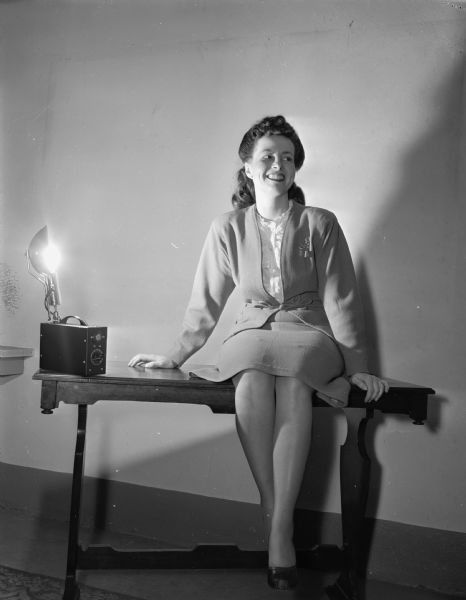 June D. (Mrs. Sheldon) Wengel serving as a model for a remote flash tripped via a photo-electric cell invented in Madison by Sheldon Wengel and Howard La Court of the Wencor Instrument Company.