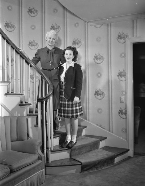 Mrs. Oscar Rennebohm (Mary) and her daughter, Carol Rennebohm, on the stairway in their Maple Bluff home, 201 Farwell Drive.
