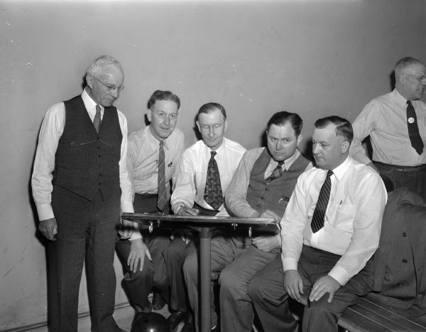 Madison Elks, at the scoring table, ready to take part in the 27th Annual Elks National Bowling Tournament at the Plaza Alleys, 319 North Henry Street. Left to right: William Devine, E.M. Dowdle, Harry Marsh, J.M. Beveridge and Arthur M. Kurtz. All are former exalted rulers of the Madison lodge.