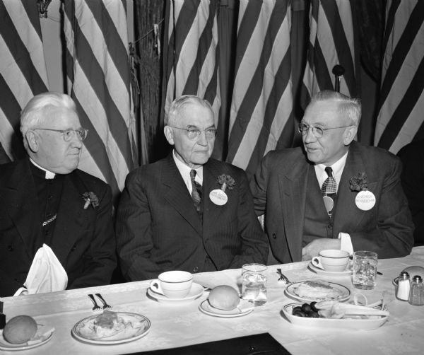 Group portrait taken at Wisconsin Legislative banquet. Pictured left to right: Bishop William P. O'Connor, Bishop of the Catholic Diocese of Madison, Judge Marvin B. Rosenberry, Chief Justice of the Wisconsin Supreme Court, and Governor Oscar Rennebohm, State of Wisconsin. The banquet was sponsored by the Madison and Wisconsin Foundation.