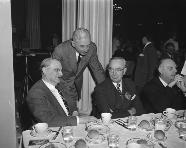 Group portrait taken at Wisconsin Legislative banquet. Pictured left to right: Joe Rothschild, Manager, Baron's Department store; Thomas Coleman, President, Madison-Kipp Corporation, and two unidentified businessmen. Banquet was sponsored by the Madison and Wisconsin Foundation.