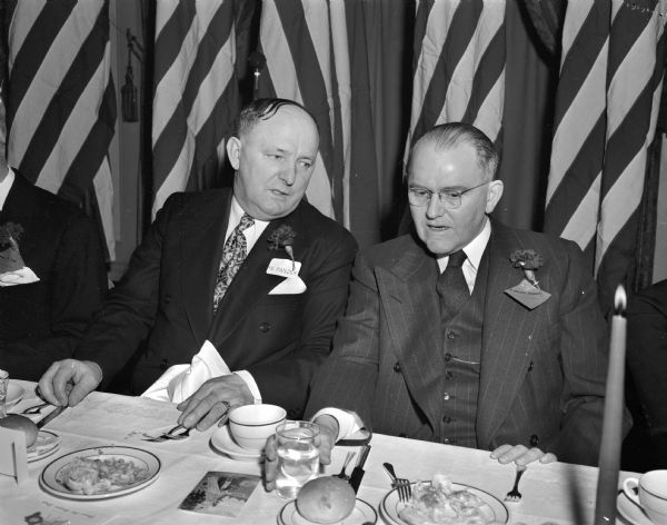 Two men at the Wisconsin legislative banquet. Pictured left to right: Frank E. Panzer, Republican from Dodge and Washington Counties, Legislature President pro tempore, and Mayor F. Halsey Kraege, Mayor of Madison. Banquet was sponsored by the Madison and Wisconsin Foundation.