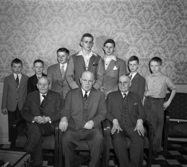 YMCA 28th annual meeting. Grandfathers and grandsons receive gold pins.  Left to right, front row: Dr. W.W. Stebbins, L.D. Atkinson, Emil Frautschi.  Left to right, rear row:  George Longenecker, Billy Ela, Ronnie Stebbins, Walter Stebbins, Skippy Stebbins, Tim Frautschi, Dick Ela.