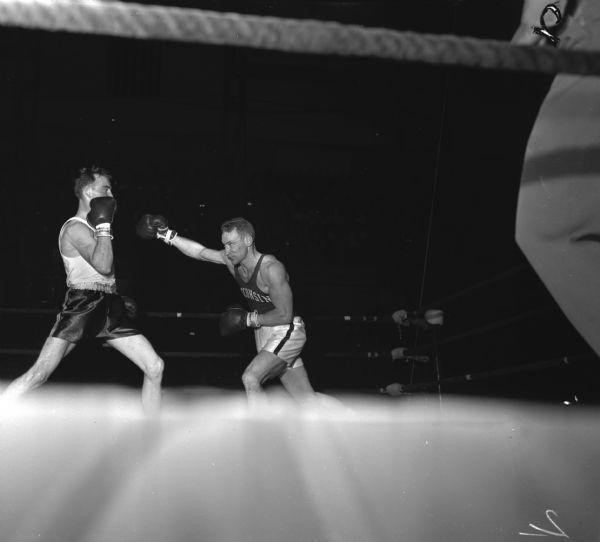Cliff Lutz (right) University of Wisconsin boxer competing against Dan Hickey of Michigan State at the National Collegiate Athletic Association national tournament at the University of Wisconsin-Madison Field House.