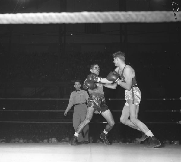 University of Wisconsin's Steve Gremban (right), competing against Jimmy Demos of Miami at the National Collegiate Athletic Association national tournament at the University of Wisconsin-Madison Field House.