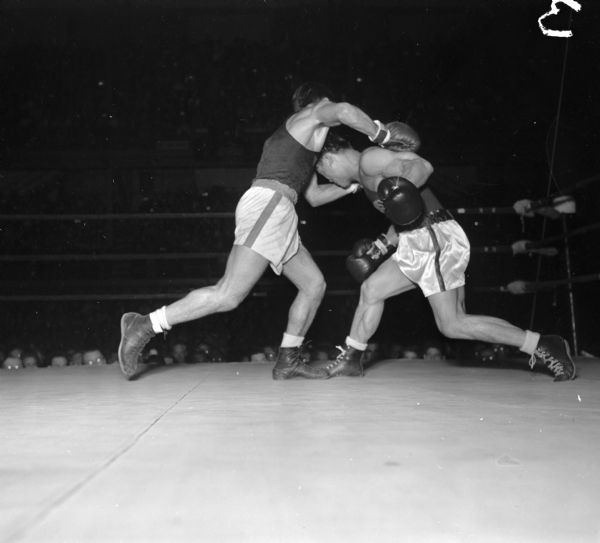 Wisconsin's Dick Miyagawa (left) competing against Basil Miragliotta of Virginia at the National Collegiate Athletic Association national tournament at the University of Wisconsin-Madison Field House.